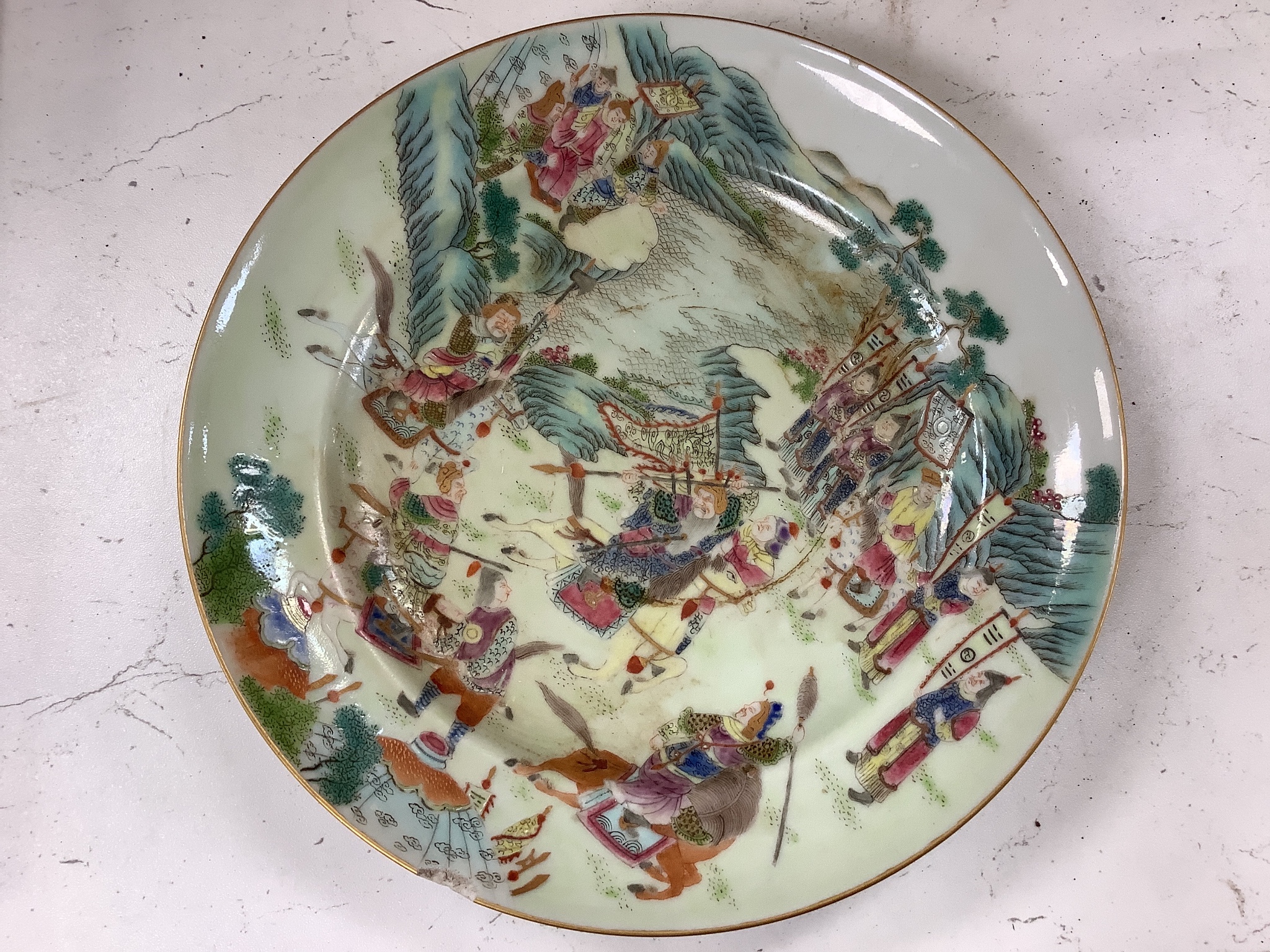 A Chinese famille rose plate and a celadon plate, diameter 24cm